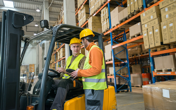 Manual Workers Working In Warehouse