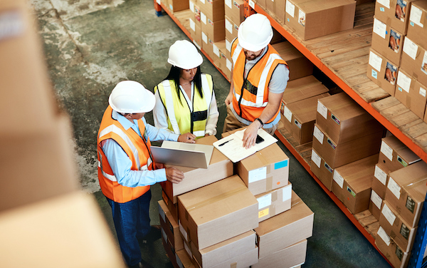 High angle shot of a group of factory workers having a discussion in a warehouse